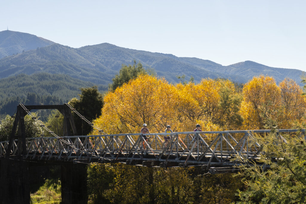 Cyclists on the Great Taste Trail, Motueka valley in Autumn