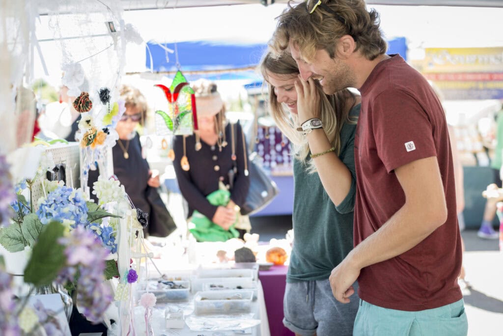 Couple browsing a stall at Motueka Sunday market